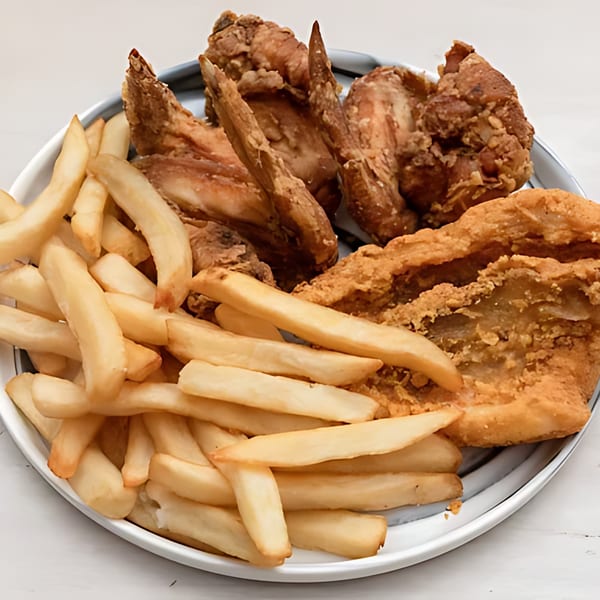 A plate of crispy fried chicken pieces and golden french fries from Harold's Chicken KSU.