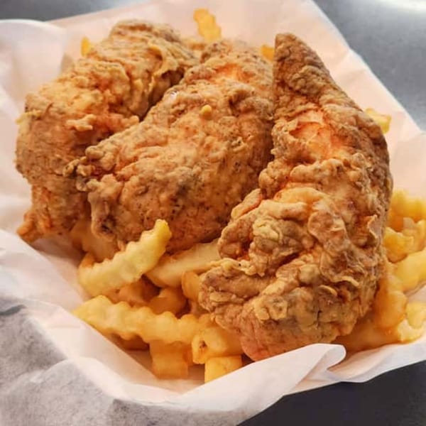 Three crispy fried chicken tenders and crinkle-cut fries served in a paper-lined basket from Harold's Chicken KSU.